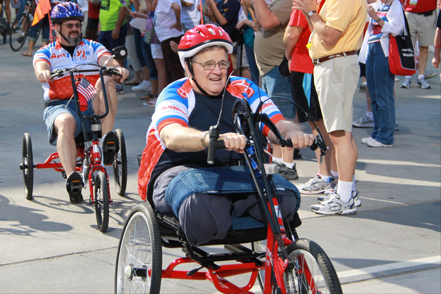 Older man with no legs racing on hand tricycle