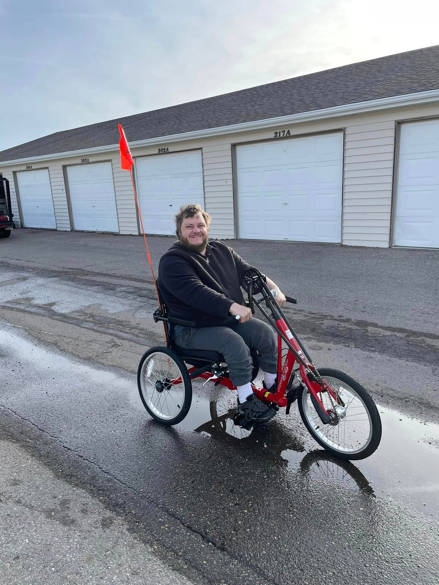 Adult man riding hand cycle on the road